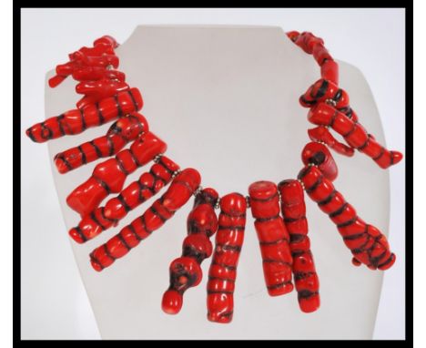 A vintage 20th century large baroque coral necklace having a white metal hook clasp. The necklace having columns of coral of 