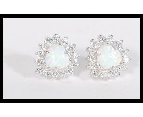 A pair of sterling silver cz and opal earrings having central opal panels with a halo of CZ stones.