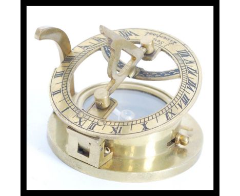 A vintage style nautical brass compass sundial compendium signed J Sewill Liverpool. The compass of circular form with two fo