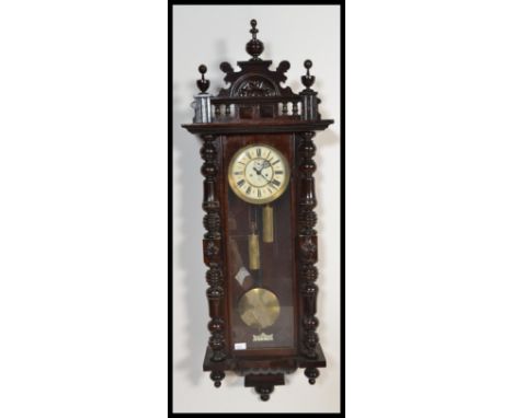 A 19th century Victorian walnut Vienna regulator wall clock by Gustav and Becker having an enamel dial marked GB with swing p
