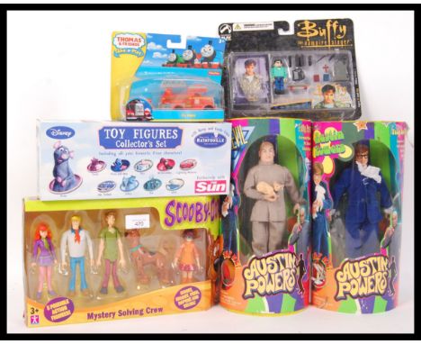 An assorted collection of original boxed film and TV related action figures to include Austin Powers by Trend Masters , Scoob