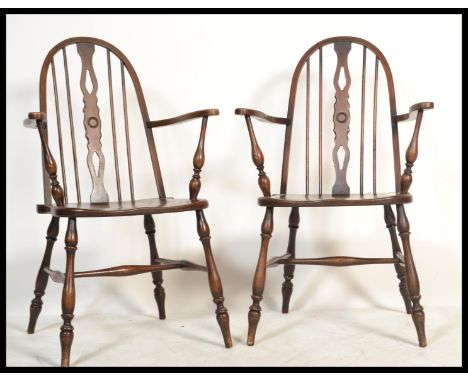 A good pair of 19th century revival beech and elm seated wheelback Windsor armchairs in the manner of Brights of Nettlebed. E