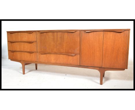 A vintage retro 20th century teak sideboard by&nbsp;Sutcliffe of Todmorden raised on tapered supports having a fall front sec