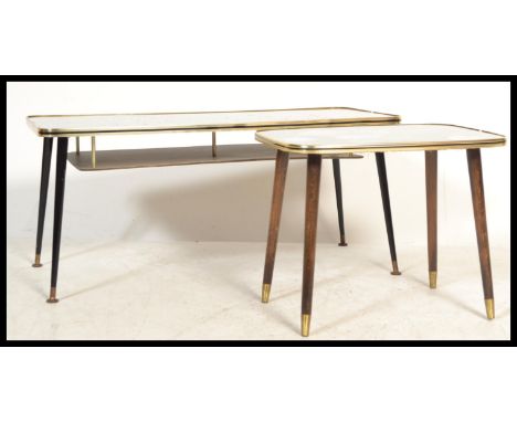 A pair of vintage mid 20th Century coffee tables, each with a striking top raised on ebonised tapering legs