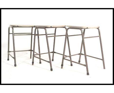 A vintage set of lab stools in grey finish with tubular metal frame.&nbsp;Measures: 60cm high x 42cm wide x 35cm deep.