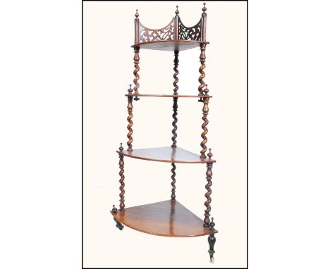 A Victorian Regency mahogany whatnot etargere of waterfall form being raised on turned legs with white ceramic castors. Above