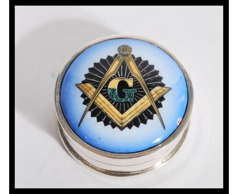 A sterling silver and enamel Masonic interest pill box of circular form. Weighs 16.9 grams.