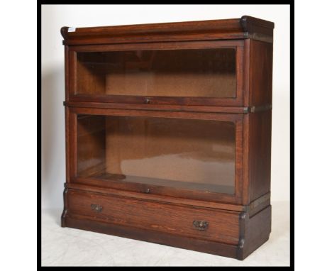 An Edwardian / early 20th century oak Lebus stacking lawyers bookcase cabinet in the manner of Globe Wernick, two sections wi