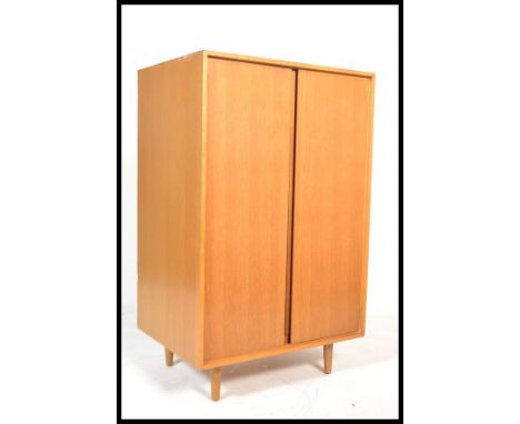 Stag Furniture C Range - A vintage retro 20th century bachelors wardrobe in light oak. The wardrobe raised on tapered support