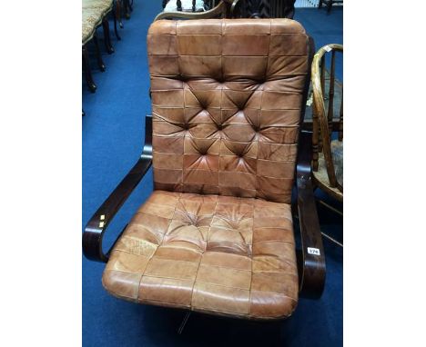 A button back tan leather swivel chair
