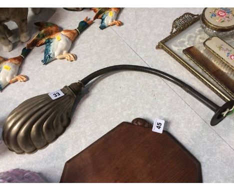 A wall mounted angle poise lamp with shell shade