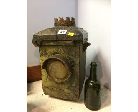 A green glass L.N.E.R. bottle and a cast iron L.N.E.R. railway lamp
