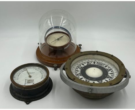 A Tangent Galvanometer by Eureka Scientific Co. Ltd in a glass dome 21cm h on a wooden base 21cm d along with a Brass Compass