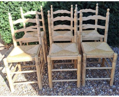 Six rush seated ladder backed dining chairs. 95cm h x 40cm w x 38cm d.