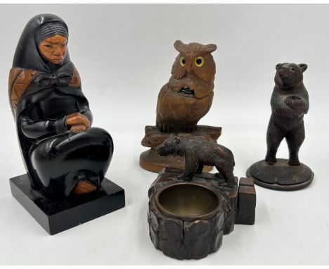 Three Black Forest carved items to include an inkwell in the form of an owl with glass eyes 15cm h, a bear ash tray/match hol