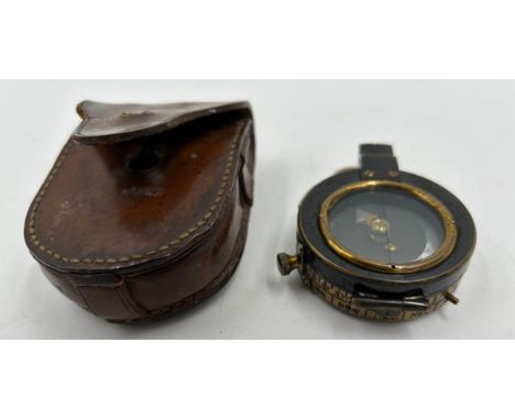 A WW1 Officers Brass Compass dated 1918 with broad arrow military mark by ST. PAN.GAR London No.95958 with leather pouch.