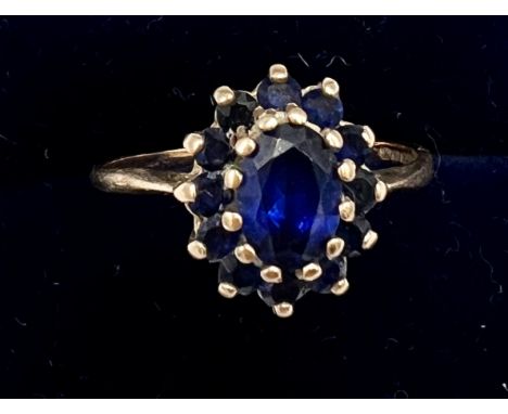 A nine carat gold ring set with blue stones. Size R, weight 2.4gm.