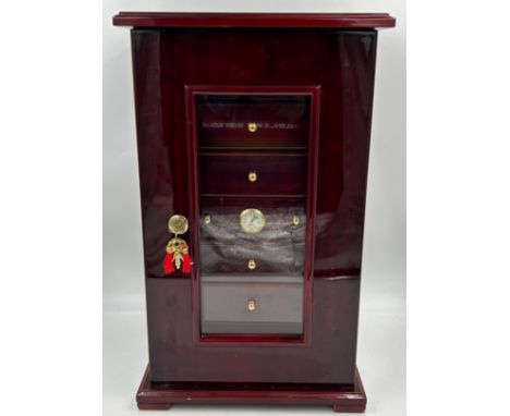 A lacquered wood humidor cabinet with a glazed door enclosing seven cigar trays and a hygrometer containing 19 x Cohiba cigar