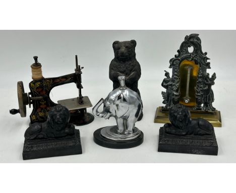 Metal items to include 19thC ornate brass desktop thermometer 18cm h, a cast iron bear, a pair of recumbent cast iron lions, 