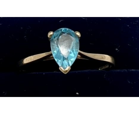 A nine carat gold ring set with blue gem stone. Size R. Weight 1.4gm.