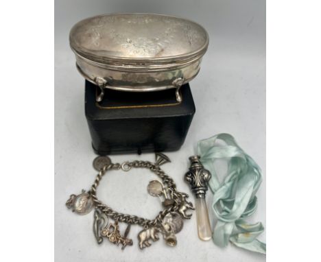 Hallmarked silver to include oval jewellery box, Birmingham 1916, charm bracelet and silver, mother of pearl whistle, Birming