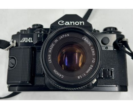 Vintage Canon SLR Camera A-1, serial no. 747108 with 50mm lens and case.
