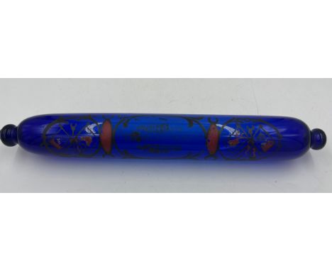 A 19thC blue glass decorated rolling pin. 37cm l.