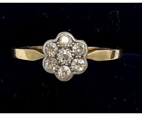 An 18 carat gold diamond cluster ring. Size Q/R, weight 2.4gm.