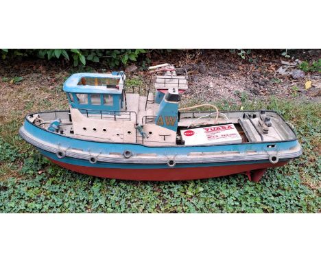 A vintage remote controlled boat. 34cm h x 76cm w x 27cm d.