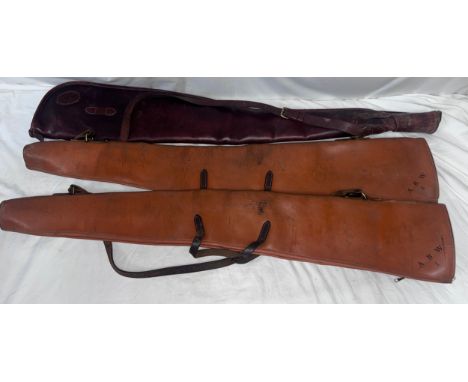 A William Evans shotgun leather slip together with two other leather slips, all initialled A.B.W. (3)