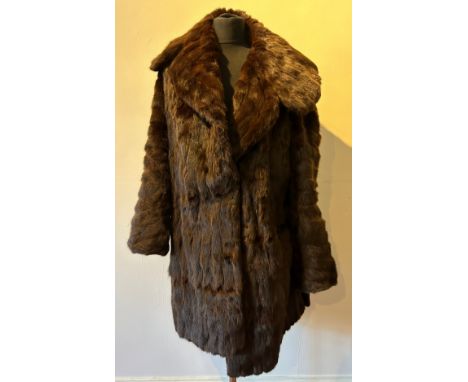 A ladies vintage fur coat with wide collar. Back of collar to hem 88cm, armpit to armpit 56cm.