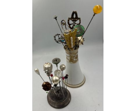 A collection of hatpins and two hatpin holders, one silver and one Noritake to include silver teddy, enamel and white metal, 