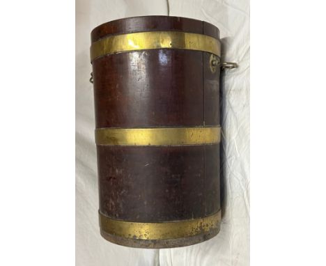 An oak brass bound bucket/planter with brass handles and interior wood partition just below halfway. 55cm h x 33cm diameter.