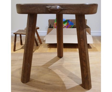 An oak three legged Robert Mouseman Thompson stool.&nbsp;30cm w x 34cm h.