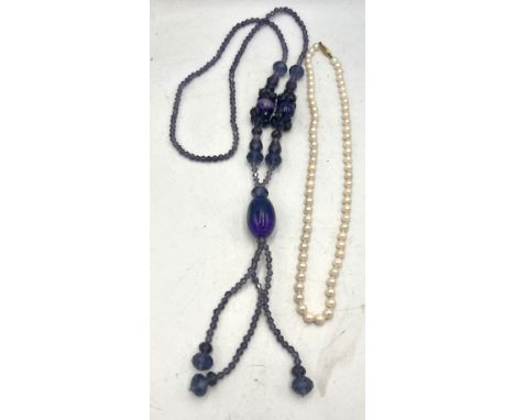 Cultured pearl necklace with 9 carat gold clasp together with a purple glass bead necklace.