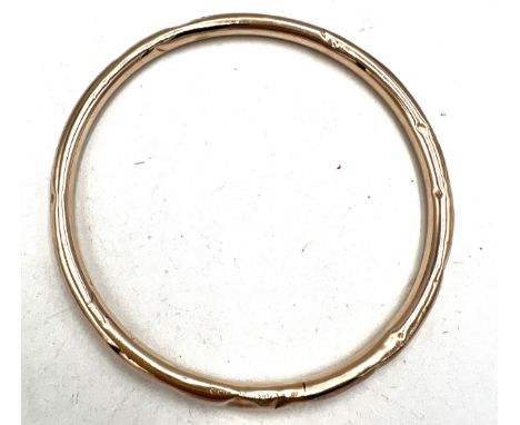 A 9 carat gold bangle. Weight 7gm.