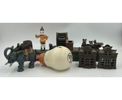 A collection of cast iron Novelty Money Boxes to include Trick Dog, Cat and Mouse, Elephant, U.S Mailbox and 2 x City Banks a