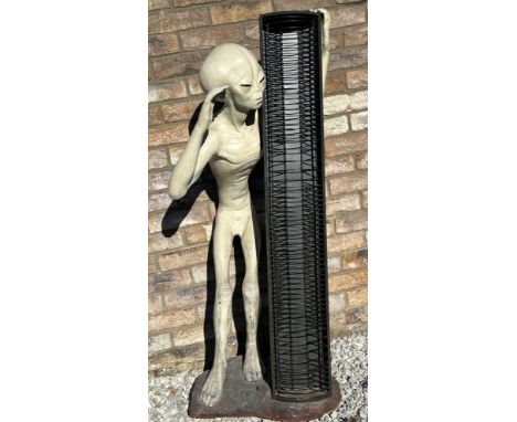A life size model of an Alien made from resin with a CD holder standing on a heavy base with makers mark to the front, 126cm 