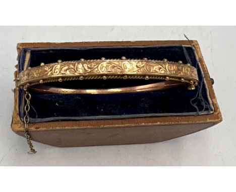 A 9 carat gold hinged bangle. Weight 7.4gm.