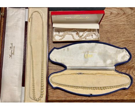 Two cultured pearl necklaces, one Lotus with 9 carat gold clasp, one with 10 carat gold clasp and simulated pearl necklace wi