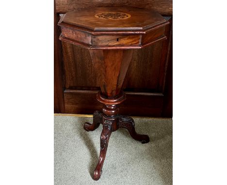 A 19thC walnut work table with tripod base. 72cm h.