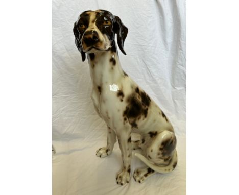 A large ceramic 'Pointer' seated hunting dog in brown and white, standing 76cm h.