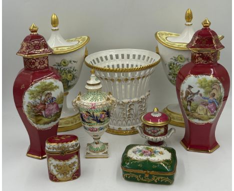 A collection of European ceramics to include a pair of Mottahedeh yellow flowered lidded Urn vases with lion head handles 31c