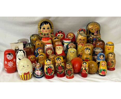 A collection of Russian Matryoshka wooden dolls to include Humpty Dumpty, Arsenal Football team, Russian Leaders, tiger, duck