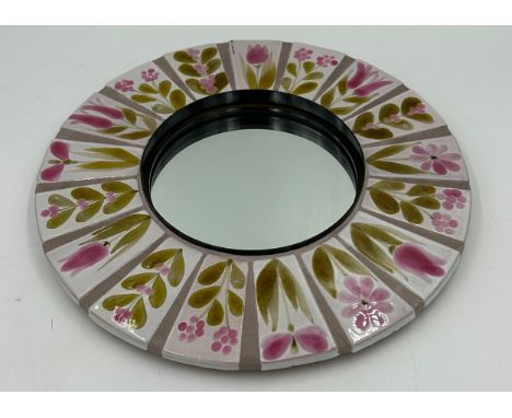 A vintage ceramic and metal mirror with floral tile decoration by Roger Capron. 39cm d.