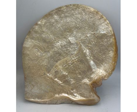 A Chinese profusely carved mother of pearl shell. 21cm x 20cm, diagonal 23cm. Does not stand unaided.
