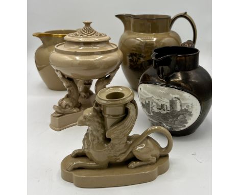 A group of early 19th century brown drabware pieces, some Spode, c. 1820 to include: two bat printed jugs, a candlestick hold