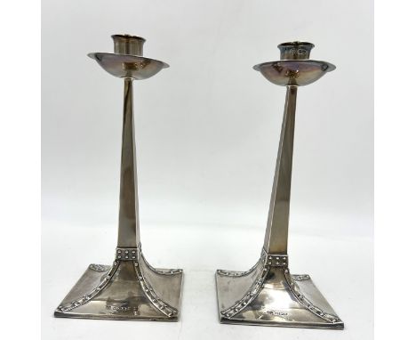 A pair of Arts and Crafts silver candlesticks with weighted bases. Sheffield 1905, maker R&amp;W Sorley of Glasgow. 22cm h.