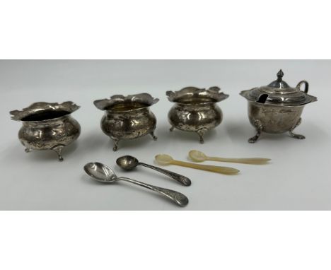 Three Silver Salt Cellars engraved with J and a spoon by Charles Edwards London 1907, a Mustard Pot with blue glass liner by 