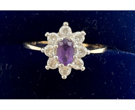 A nine carat gold ring set with purple stone and cubic zirconia. Size R. Weight 1.8gm.